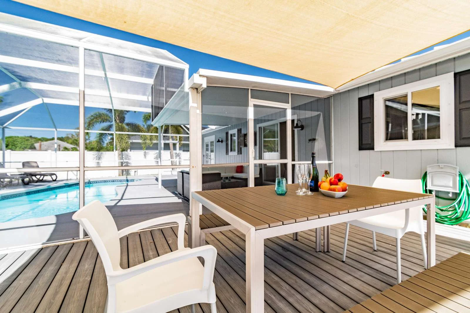 Outdoor dining beside private pool